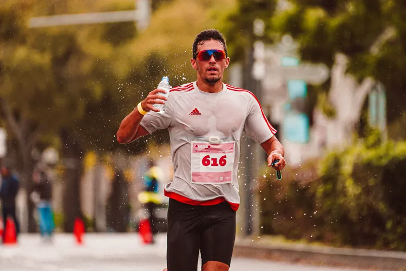 Corredor bebendo água durante uma meia maratona