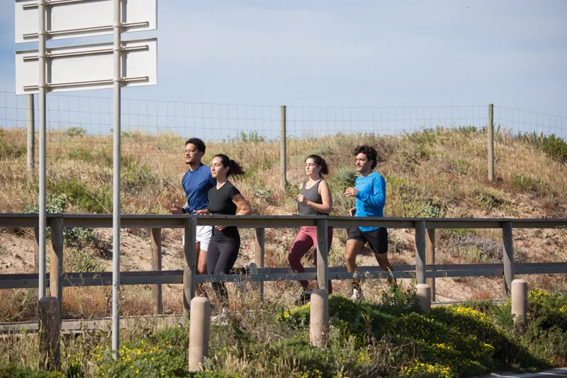 Grupo de corredores treinando junto ao ar livre